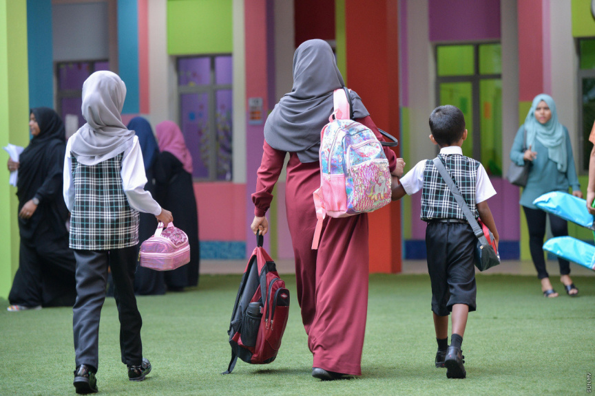 Working mothers take their kids to school.